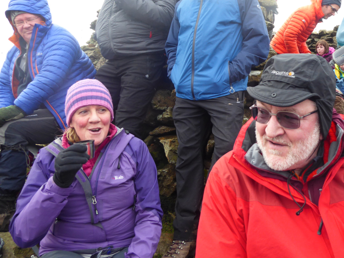 Susan and Paul outside of the summit shelter on Moel Eilio.